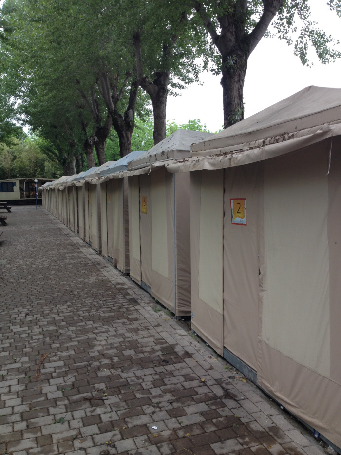 A series of canvas tents in a row